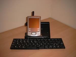 My Palm Tungsten E2 sat in the cradle built in to the palm universal wireless keyboard.